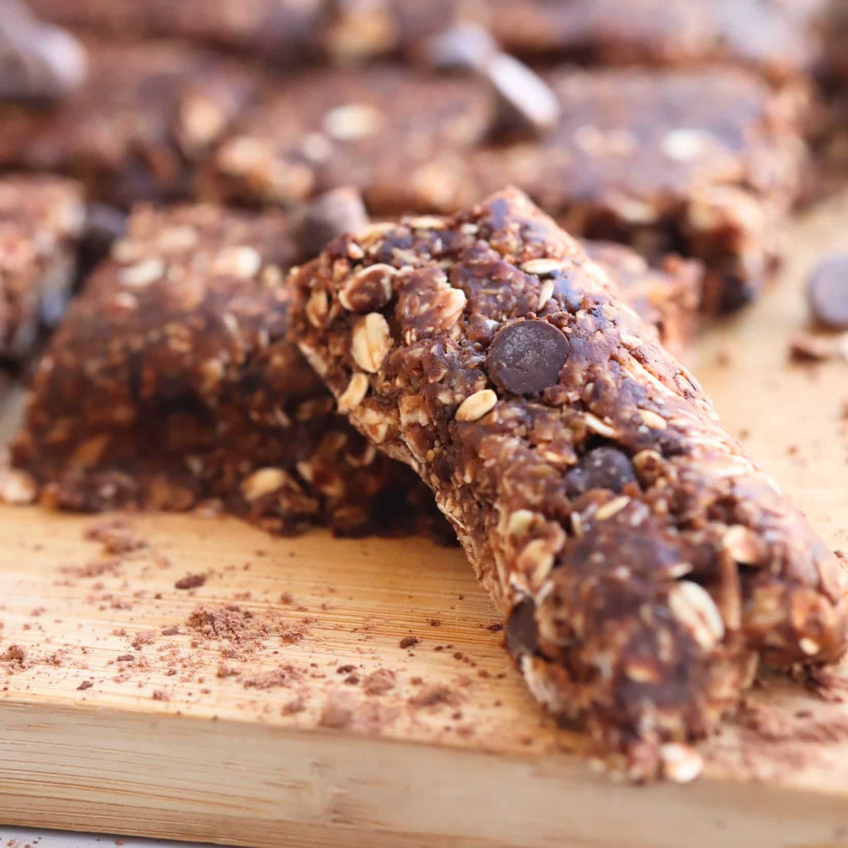 homemade chocolate granola bars sitting on a cutting board