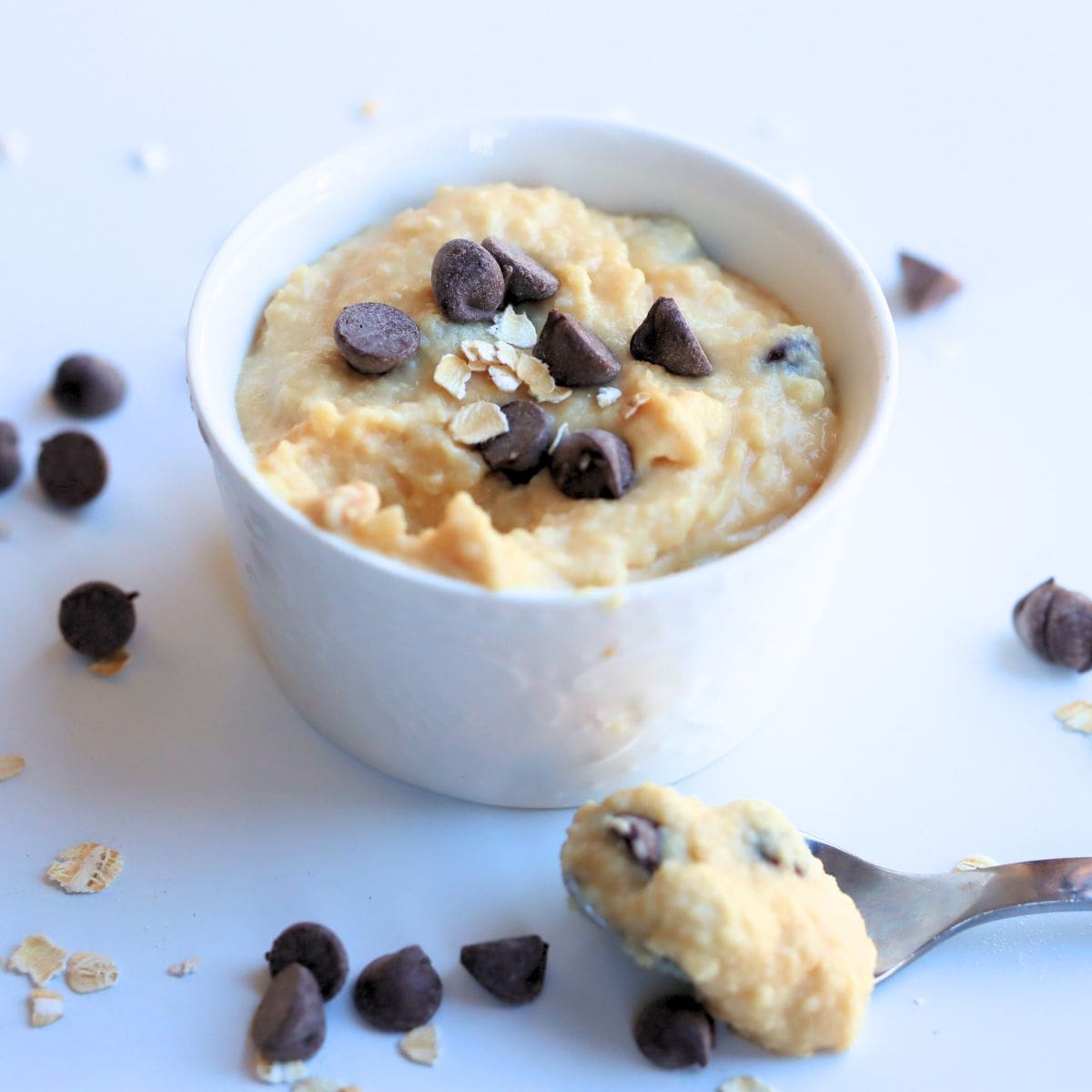 chocolate chip cookie dough yogurt in a white bowl and on a spoon