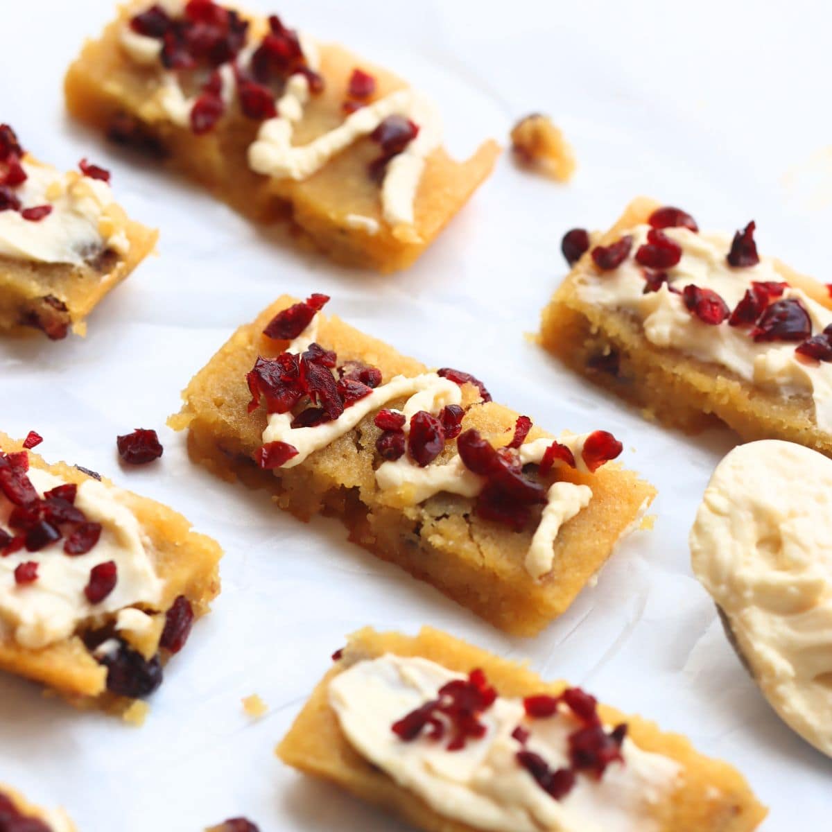 Starbucks bliss bars with lemon zest and cranberries on a white background