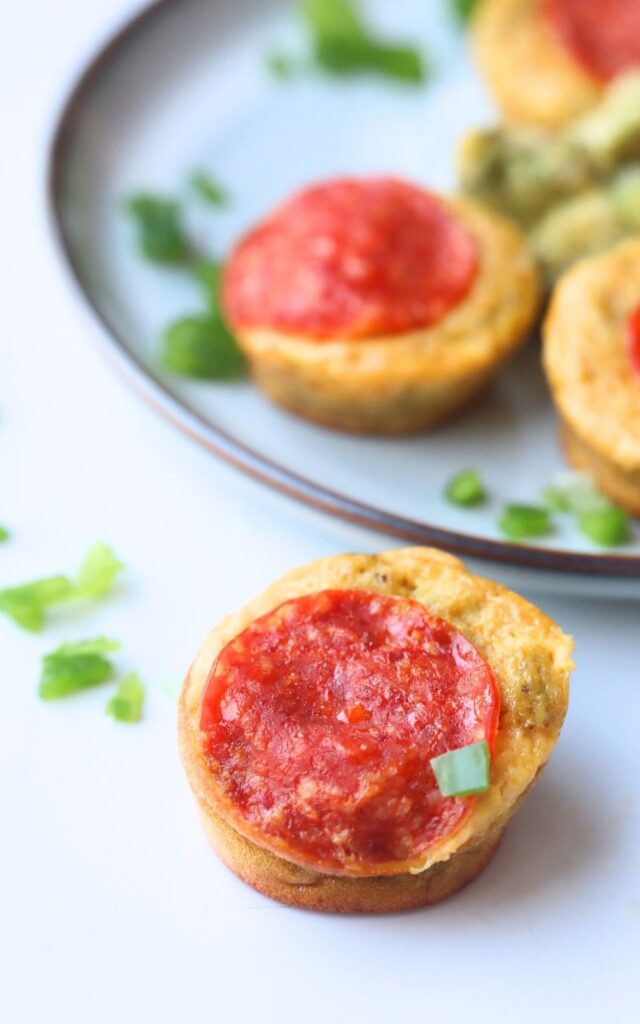 a gluten-free pizza bite made of eggs with pepperoni on a white background