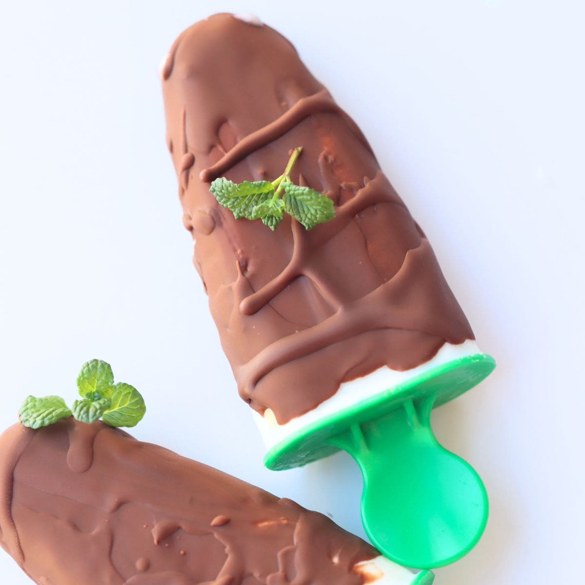 sugar free chocolate mint yogurt ice cream on a green popsicle stick