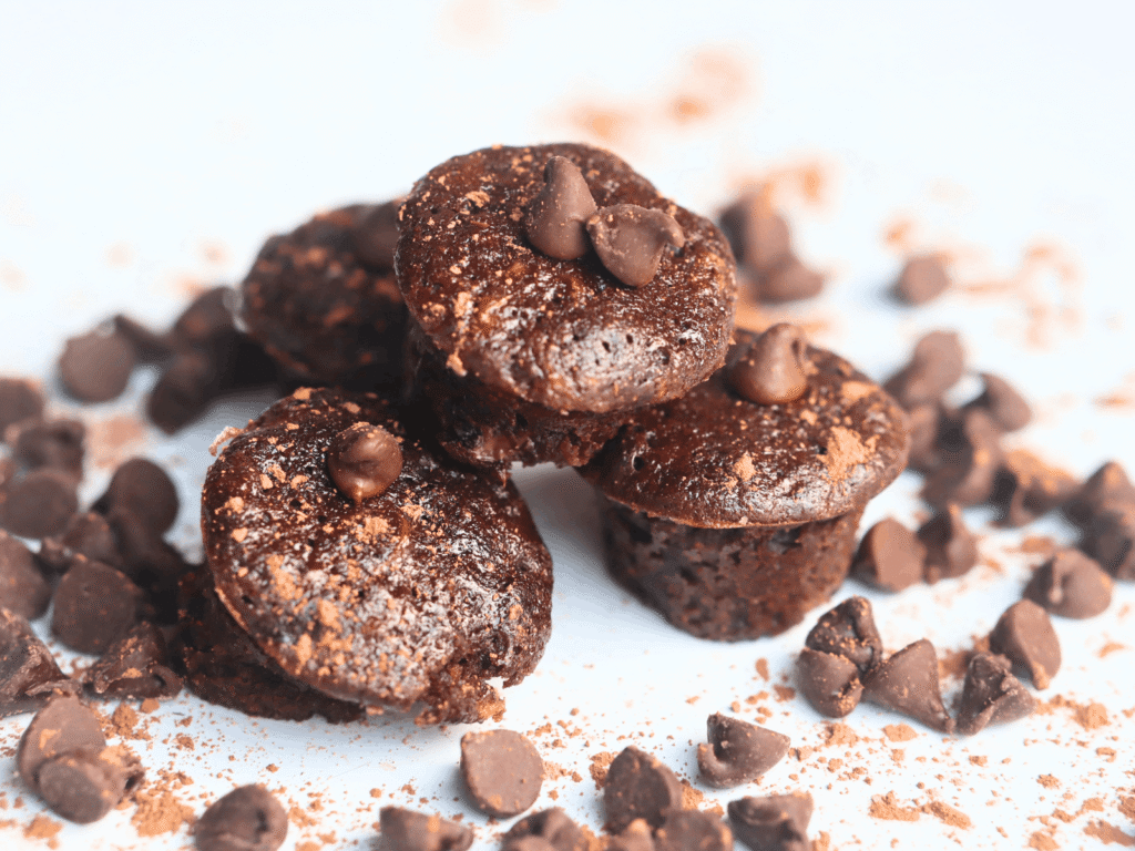 pile of healthy whole wheat chocolate muffins with zucchini and yogurt and honey