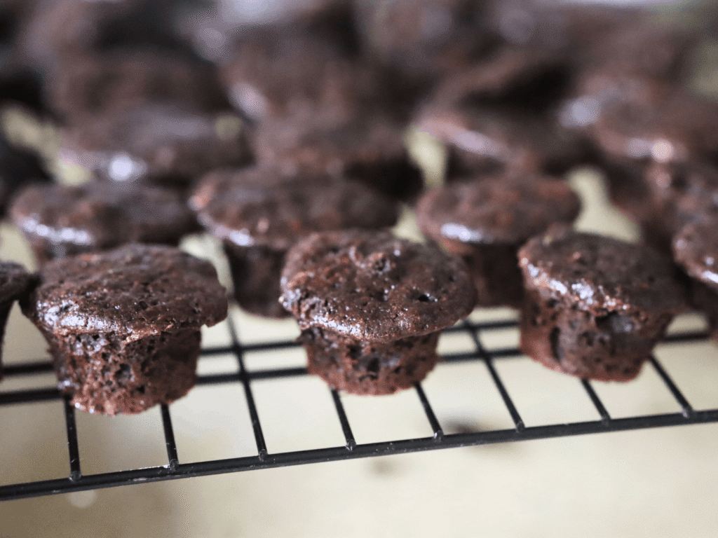 chocolate zucchini muffins cooling on a wire rack