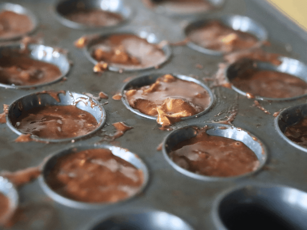 healthy chocolate muffin batter in a silicone mini muffin tin