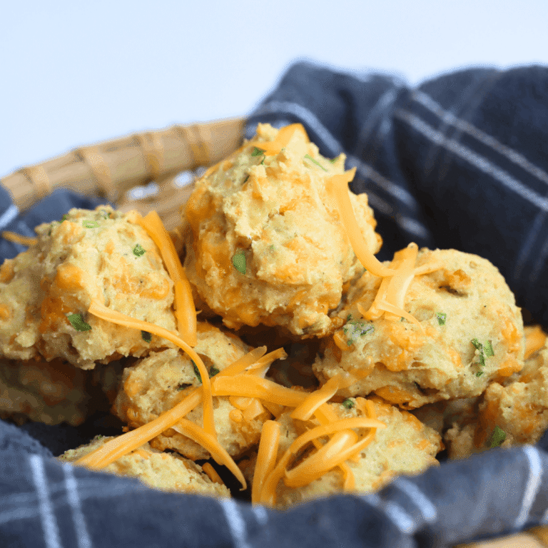 olive oil biscuits in a basket with a striped towel